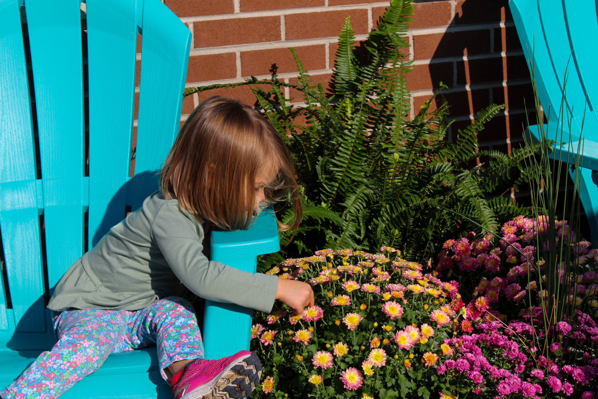 kid playing with flowers